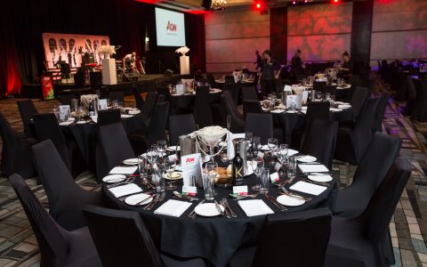 Ozaccom team members preparing tables for a Gala dinner